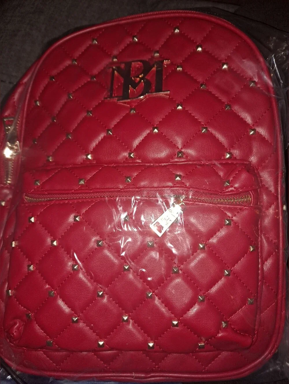 Badgley Mischka quilted vegan leather backpack featuring gold studded accents